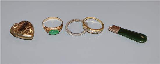 An 18k 750 and channel set diamond ring, a 585 and jade ring, a diamond eternity ring(a.f.) and two pendants.